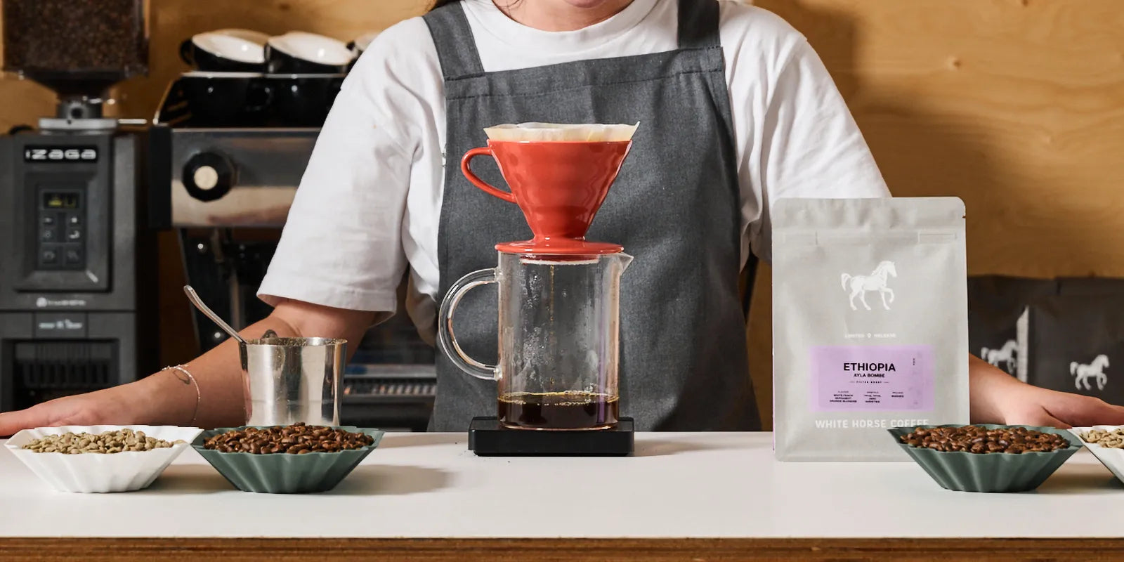 Barista brewing Ethiopian single origin coffee through a drip filter