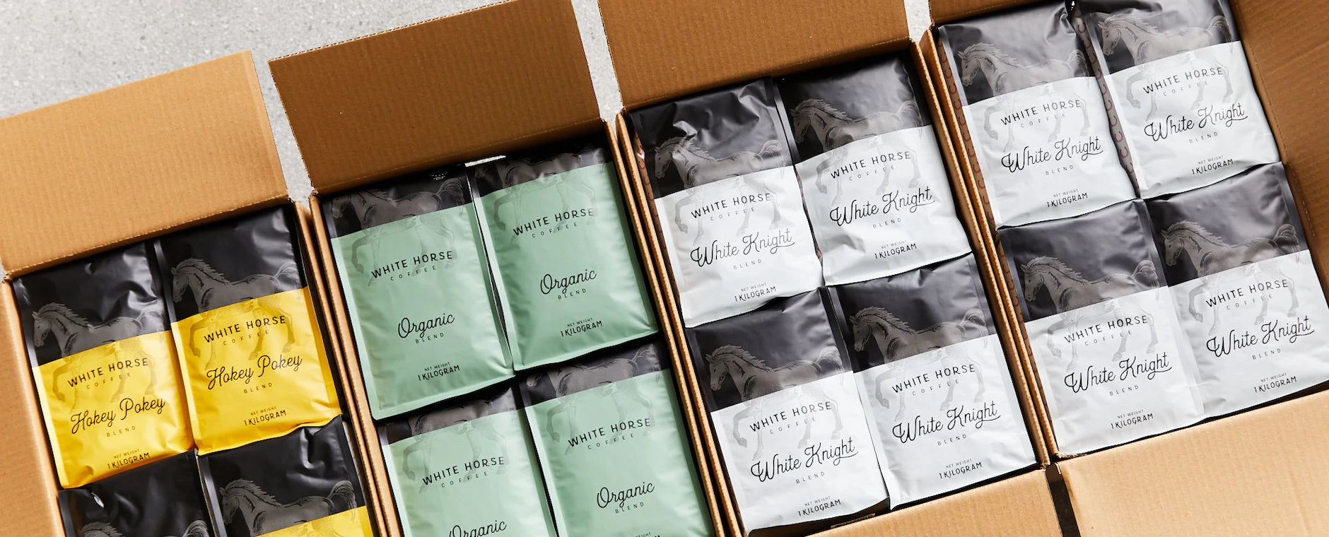 Boxes of White Horse Coffee's various blends